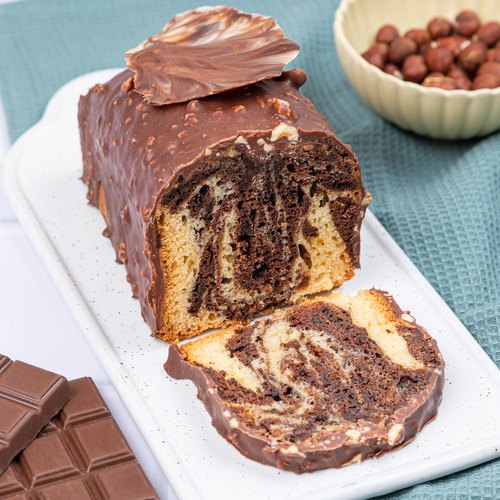 Premium Photo | Loaf marble cake slice on white marble background, served  with tea. concept white bakery product