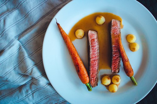Steak de boeuf, carottes roties, pommes noisettes et son jus